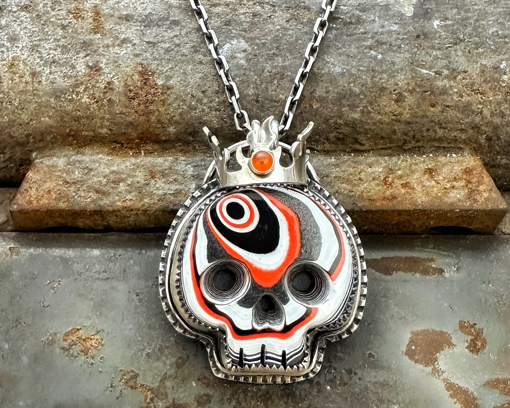 Fordite Skull with Carnelian