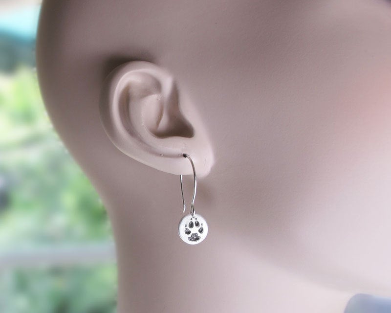 Tiny paw print earrings in silver