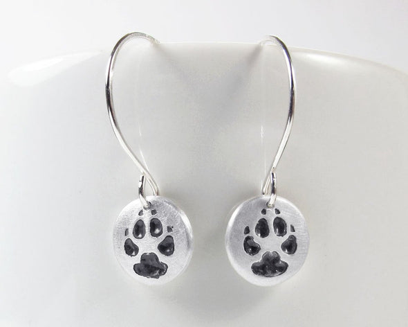 Tiny paw print earrings in silver